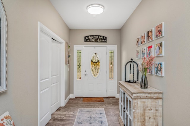 entrance foyer featuring baseboards and wood finished floors