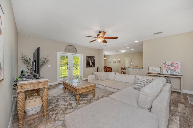 living area featuring french doors, wood finished floors, visible vents, ceiling fan, and baseboards