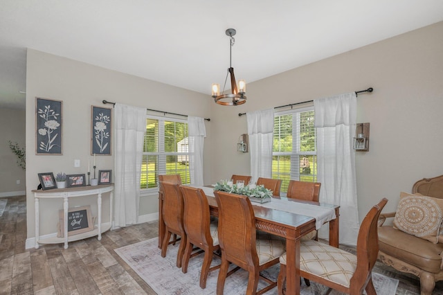 dining space featuring a wealth of natural light, a chandelier, and baseboards
