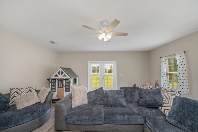 living room featuring ceiling fan, a wealth of natural light, and visible vents