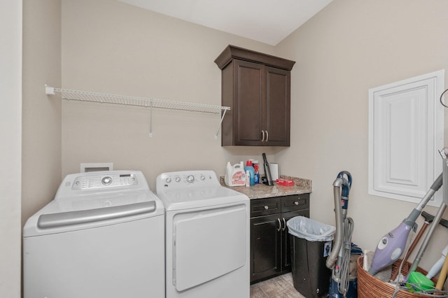 laundry room with cabinet space, washing machine and clothes dryer, and light wood finished floors