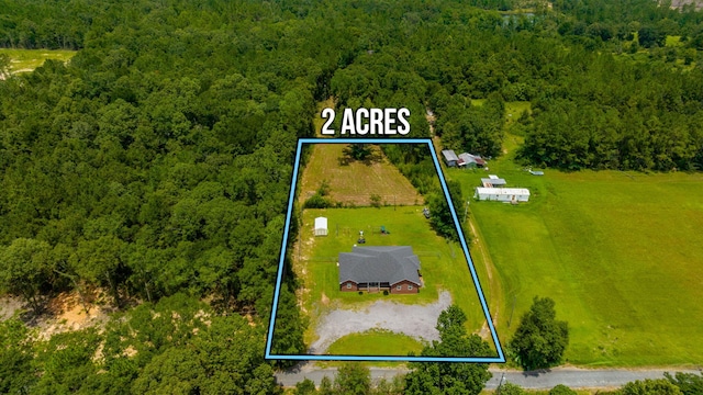 birds eye view of property with a forest view