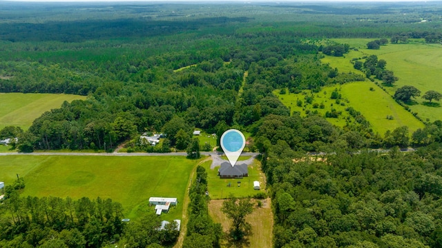 birds eye view of property featuring a rural view and a forest view