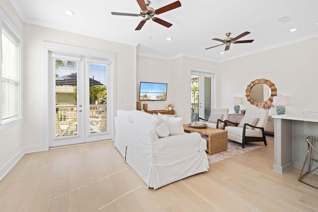 living room with ceiling fan, light wood finished floors, recessed lighting, crown molding, and baseboards