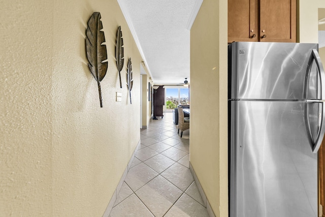 502 Gulf Shore Dr Unit 413, Destin, FL 32541 - hallway featuring light tile patterned flooring, baseboards, and a textured wall