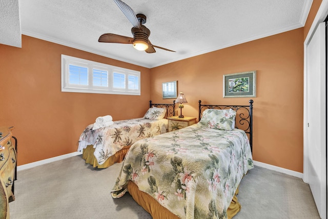 502 Gulf Shore Dr Unit 413, Destin, FL 32541 - carpeted bedroom featuring a closet, ornamental molding, a textured ceiling, baseboards, and ceiling fan
