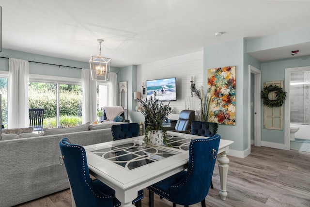 515 Topsl Beach Blvd # 106, Miramar Beach, FL 32550 - dining space with baseboards, a notable chandelier, and light wood-style flooring