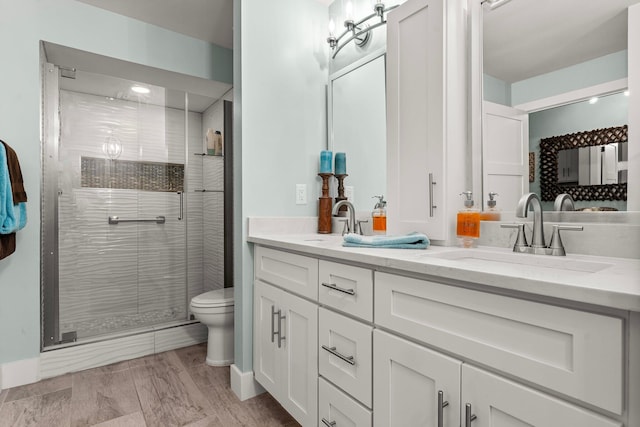 515 Topsl Beach Blvd # 106, Miramar Beach, FL 32550 - full bathroom featuring a shower stall, toilet, double vanity, and a sink