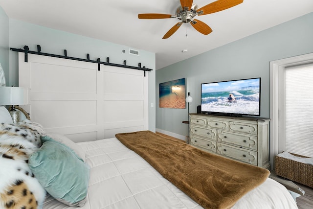 515 Topsl Beach Blvd # 106, Miramar Beach, FL 32550 - bedroom with baseboards, visible vents, a barn door, and a ceiling fan