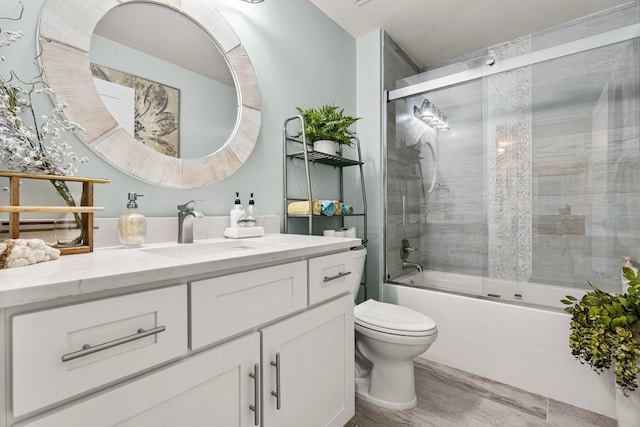 515 Topsl Beach Blvd # 106, Miramar Beach, FL 32550 - full bath featuring vanity, toilet, shower / bath combination with glass door, and wood finished floors