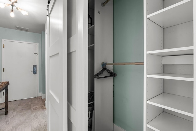 515 Topsl Beach Blvd # 106, Miramar Beach, FL 32550 - walk in closet featuring visible vents and wood finished floors