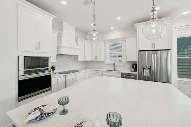 kitchen featuring black appliances, custom exhaust hood, light countertops, a sink, and tasteful backsplash