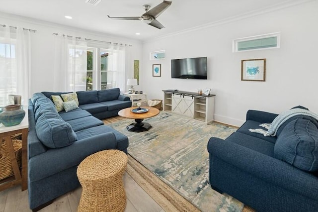 living room featuring wood finished floors, ornamental molding, a ceiling fan, recessed lighting, and baseboards