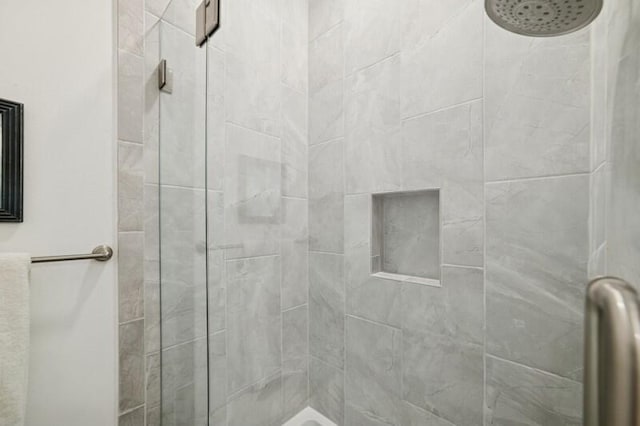 full bath featuring a tile shower