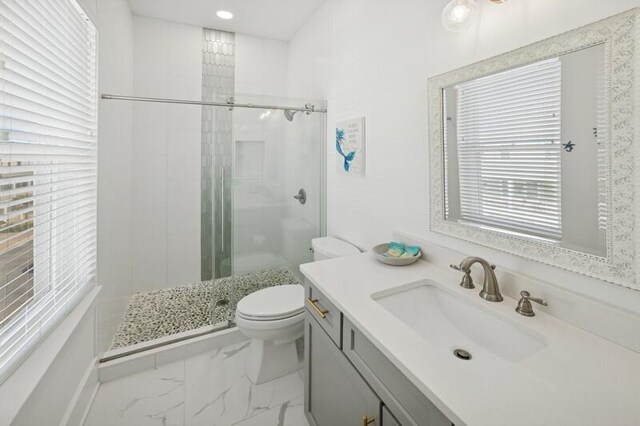 full bath featuring a shower stall, toilet, marble finish flooring, and vanity