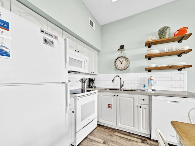 kitchen with white appliances, a sink, open shelves, tasteful backsplash, and white cabinetry
