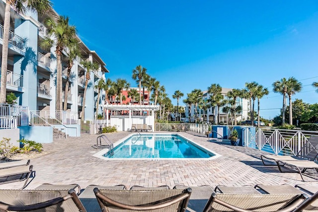 community pool featuring a patio and fence