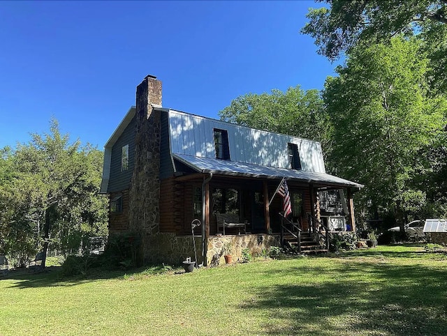941 Walton Bridge Rd, Ponce De Leon, FL 32455 - view of front of house with a porch, a front lawn, metal roof, and a chimney