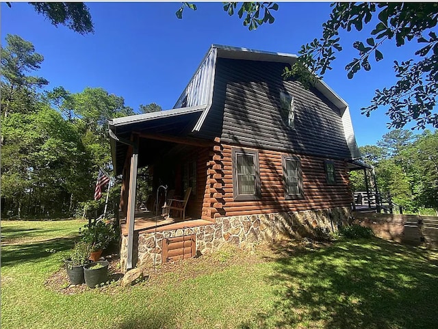 941 Walton Bridge Rd, Ponce De Leon, FL 32455 - view of home's exterior with a lawn, log siding, and a gambrel roof