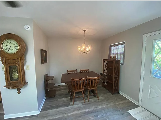 941 Walton Bridge Rd, Ponce De Leon, FL 32455 - dining room with a chandelier, wood finished floors, and baseboards