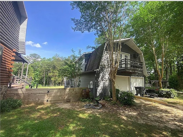 941 Walton Bridge Rd, Ponce De Leon, FL 32455 - view of home's exterior with a gambrel roof, a garage, and a balcony