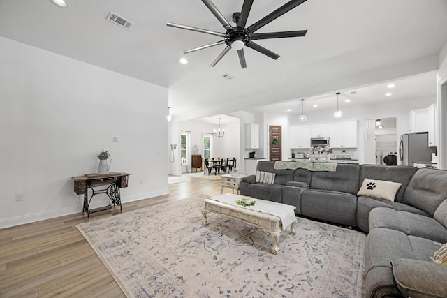 5881 Stacy Ln, Crestview, FL 32536 - living room with recessed lighting, a chandelier, light wood-style floors, a ceiling fan, and baseboards
