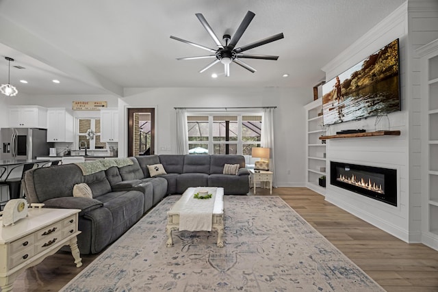 5881 Stacy Ln, Crestview, FL 32536 - living room with a glass covered fireplace, recessed lighting, a ceiling fan, wood finished floors, and baseboards