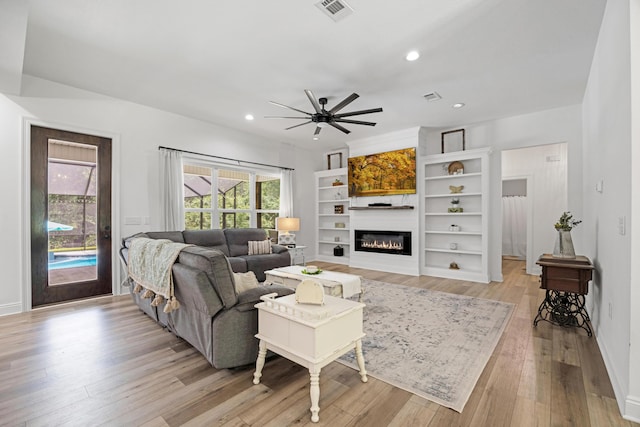 5881 Stacy Ln, Crestview, FL 32536 - living area with a glass covered fireplace, ceiling fan, light wood-type flooring, recessed lighting, and baseboards