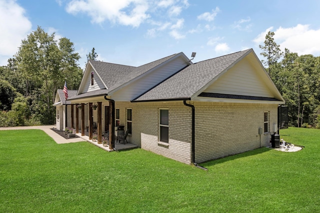 5881 Stacy Ln, Crestview, FL 32536 - back of house featuring roof with shingles, a lawn, brick siding, and a patio