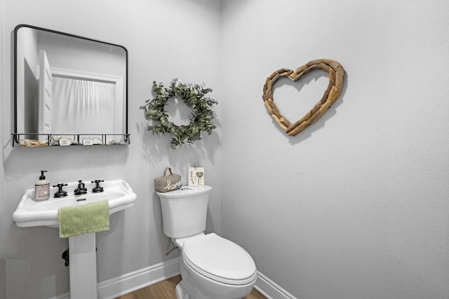 5881 Stacy Ln, Crestview, FL 32536 - bathroom with baseboards, wood finished floors, and toilet