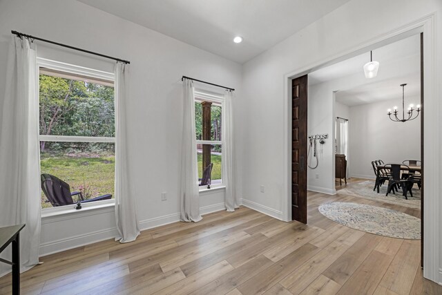 5881 Stacy Ln, Crestview, FL 32536 - dining space with light wood-style floors, a chandelier, and baseboards