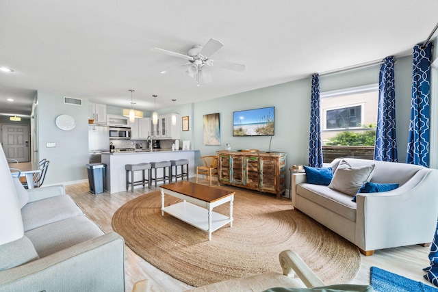 8294 E County Highway 30a Unit 1, Alys Beach, FL 32461 - living area featuring a ceiling fan and light wood finished floors