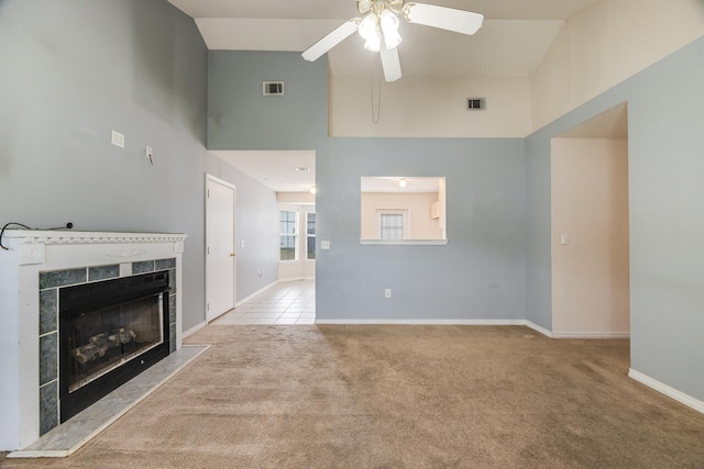 15 Flora Cv, Crestview, FL 32539 - unfurnished living room with carpet flooring, a premium fireplace, a ceiling fan, baseboards, and a towering ceiling