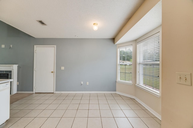 15 Flora Cv, Crestview, FL 32539 - unfurnished dining area featuring baseboards, a textured ceiling, and light tile patterned floors