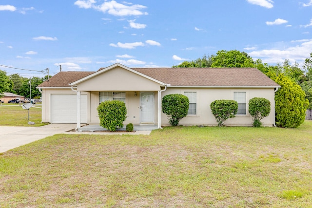 15 Flora Cv, Crestview, FL 32539 - ranch-style home featuring an attached garage, driveway, stucco siding, and a front yard