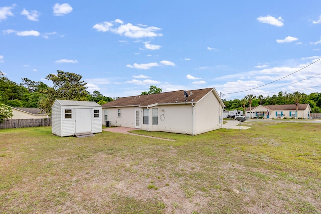 15 Flora Cv, Crestview, FL 32539 - rear view of house featuring a shed, an outbuilding, and stucco siding
