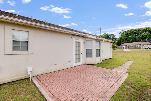 15 Flora Cv, Crestview, FL 32539 - back of property featuring a patio, a yard, and stucco siding
