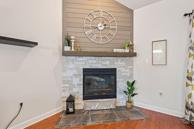 4475 New Market Rd, Niceville, FL 32578 - detailed view of wood finished floors, baseboards, and a stone fireplace