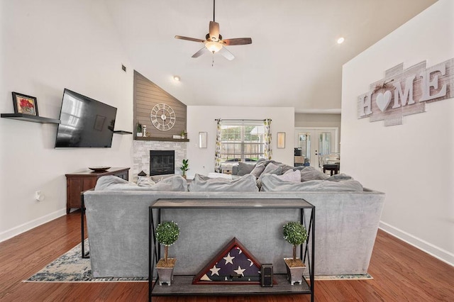 4475 New Market Rd, Niceville, FL 32578 - living area with baseboards, ceiling fan, high vaulted ceiling, a fireplace, and wood finished floors