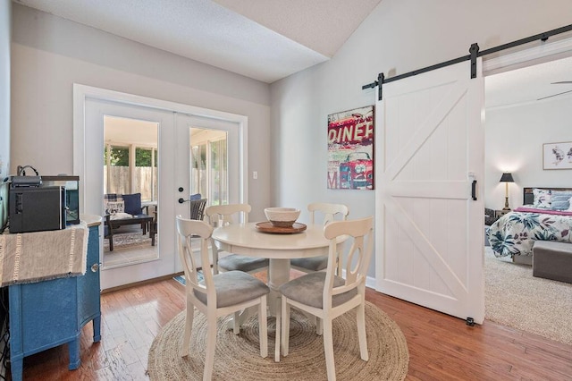 4475 New Market Rd, Niceville, FL 32578 - dining room featuring a barn door, french doors, and light wood-style flooring