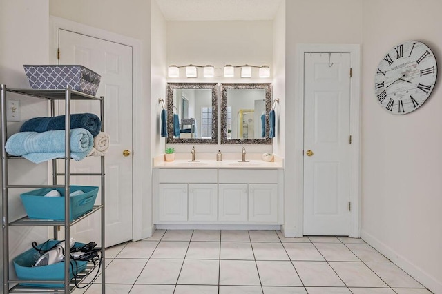 4475 New Market Rd, Niceville, FL 32578 - bathroom featuring double vanity, tile patterned flooring, and baseboards