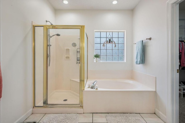 4475 New Market Rd, Niceville, FL 32578 - bathroom featuring a shower stall, a bath, a spacious closet, tile patterned floors, and recessed lighting
