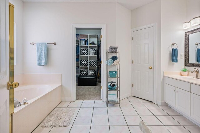 4475 New Market Rd, Niceville, FL 32578 - full bath with a garden tub, vanity, tile patterned flooring, a spacious closet, and baseboards