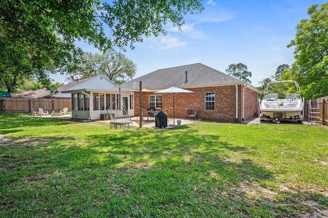 4475 New Market Rd, Niceville, FL 32578 - back of property featuring a sunroom, a patio area, and brick siding