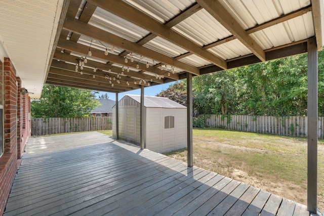 wooden deck with a storage unit and an outdoor structure