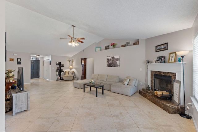 living room featuring a ceiling fan, light tile patterned floors, a fireplace, baseboards, and a textured ceiling