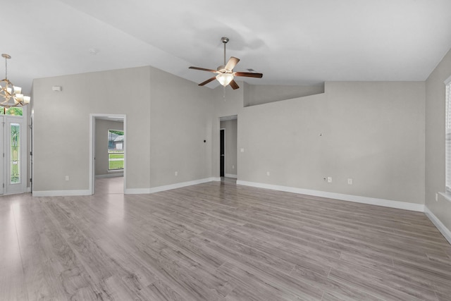 2354 Barberee Dr, Crestview, FL 32536 - unfurnished living room featuring a chandelier, a ceiling fan, light wood-style floors, high vaulted ceiling, and baseboards