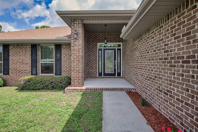 2354 Barberee Dr, Crestview, FL 32536 - doorway to property with brick siding, a lawn, and roof with shingles