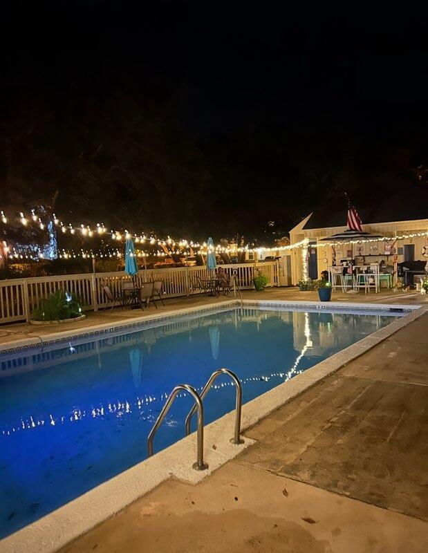 3861 Indian Trl Unit 102, Destin, FL 32541 - pool at twilight with a fenced backyard and a patio