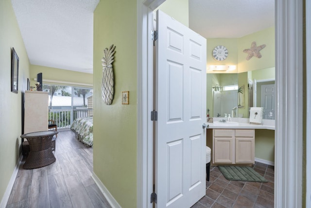 775 Gulf Shore Dr Unit 9222, Destin, FL 32541 - hallway featuring baseboards, a sink, and a textured ceiling